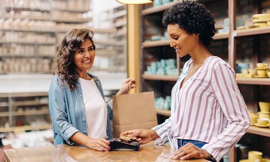 a customer using contactless payment option to pay for her purchase at a small business