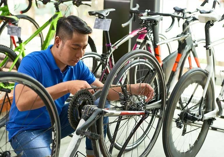 employee working on a bike at a bike shop